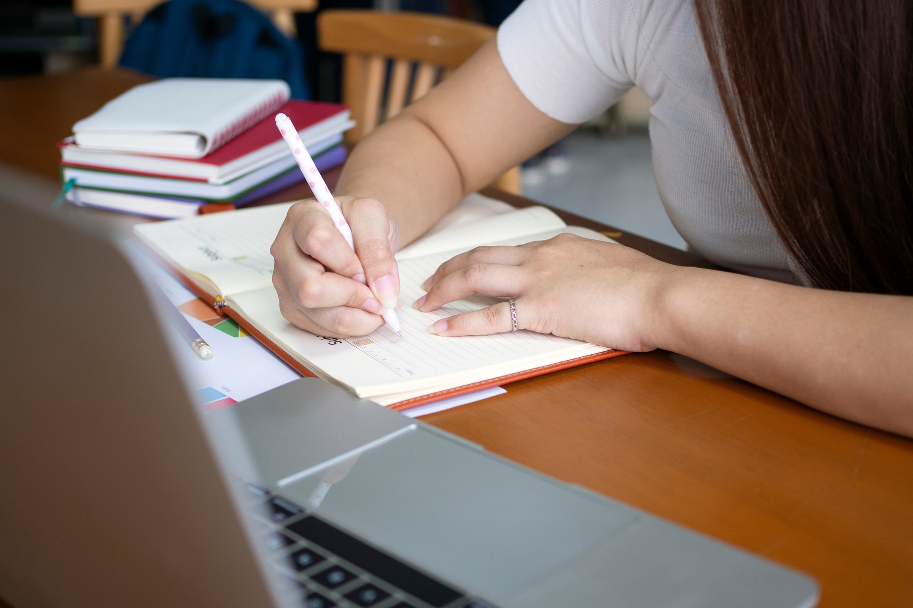 Female Student Writing on the Notebook