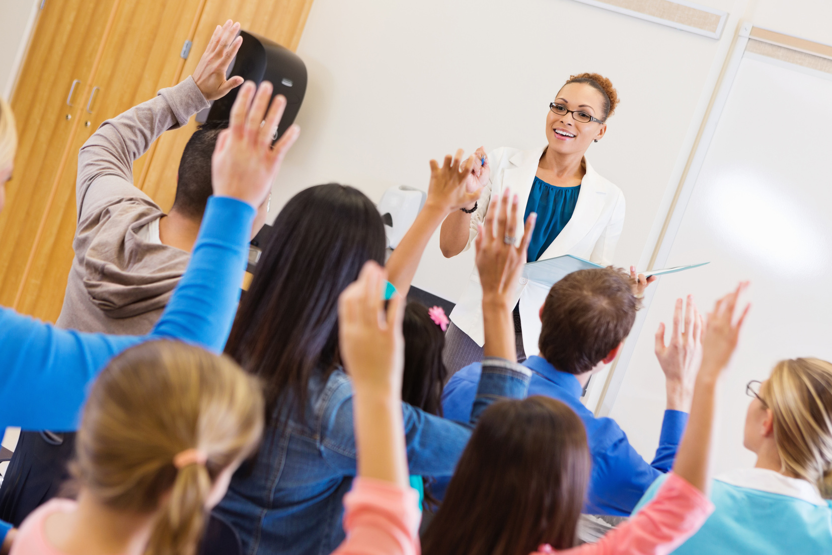 Parents and students asking questions during school assembly or orientation