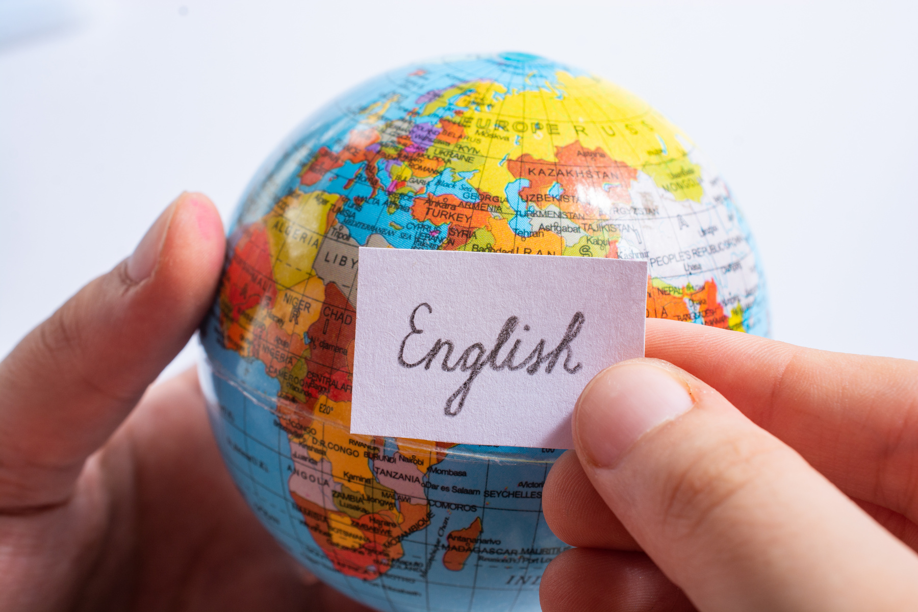 Hand Holding Notepaper with English Wording on Globe